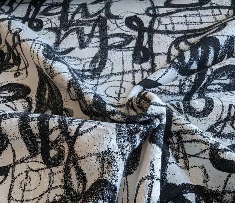 French Terry, Sweatshirtstoff, schwarze Graffiti Schrift auf Ecru